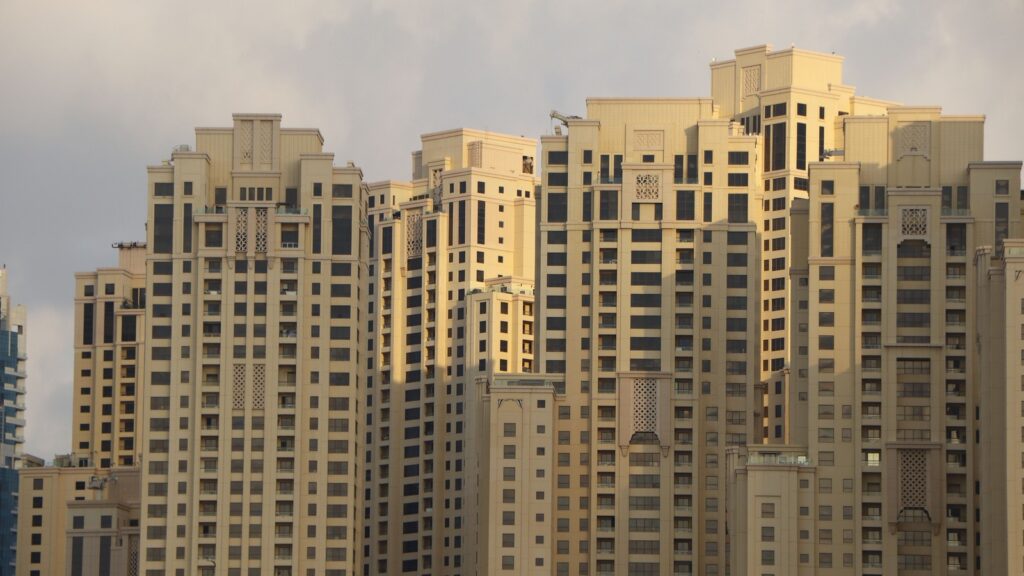 Close-up golden-hour view of cream-coloured Dubai Marina residential high-rise towers, representing Al Majara 2's Dubai Marina setting