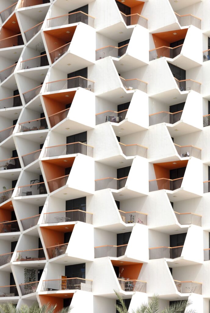 Geometric modern apartment facade with orange accents in Dubai, representative of Arjan's residential architecture