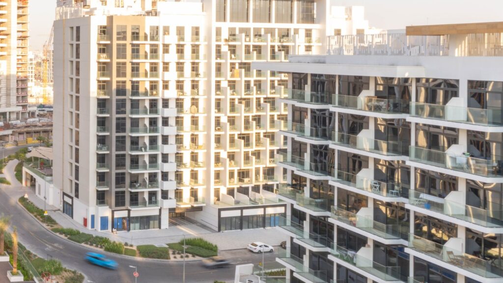 Modern residential apartment towers under golden-hour light in Dubai, representing Azizi Riviera 15's MBR City (Meydan) setting