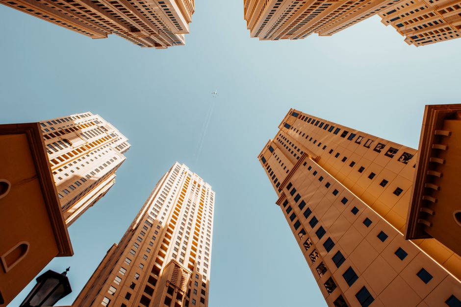 Low-angle view of Dubai high-rise apartment towers against a clear sky