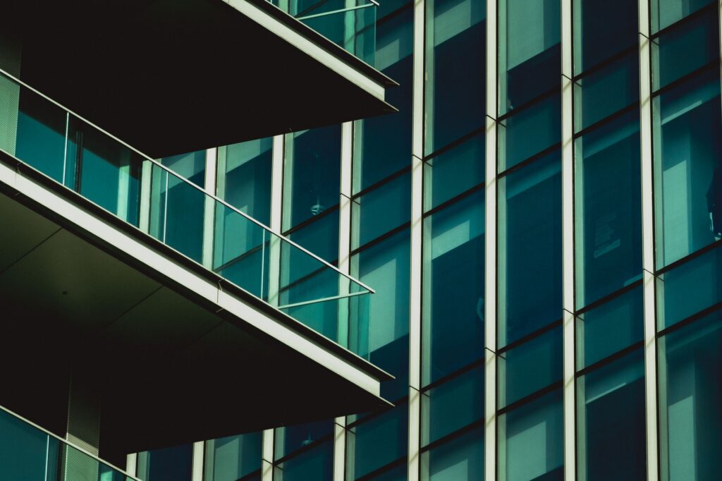 Close-up glass facade with angled balconies near Bloom Towers A, Jumeirah Village Circle, Dubai