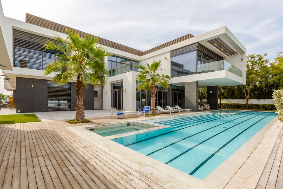 Modern Dubai luxury villa with a private swimming pool and palm trees
