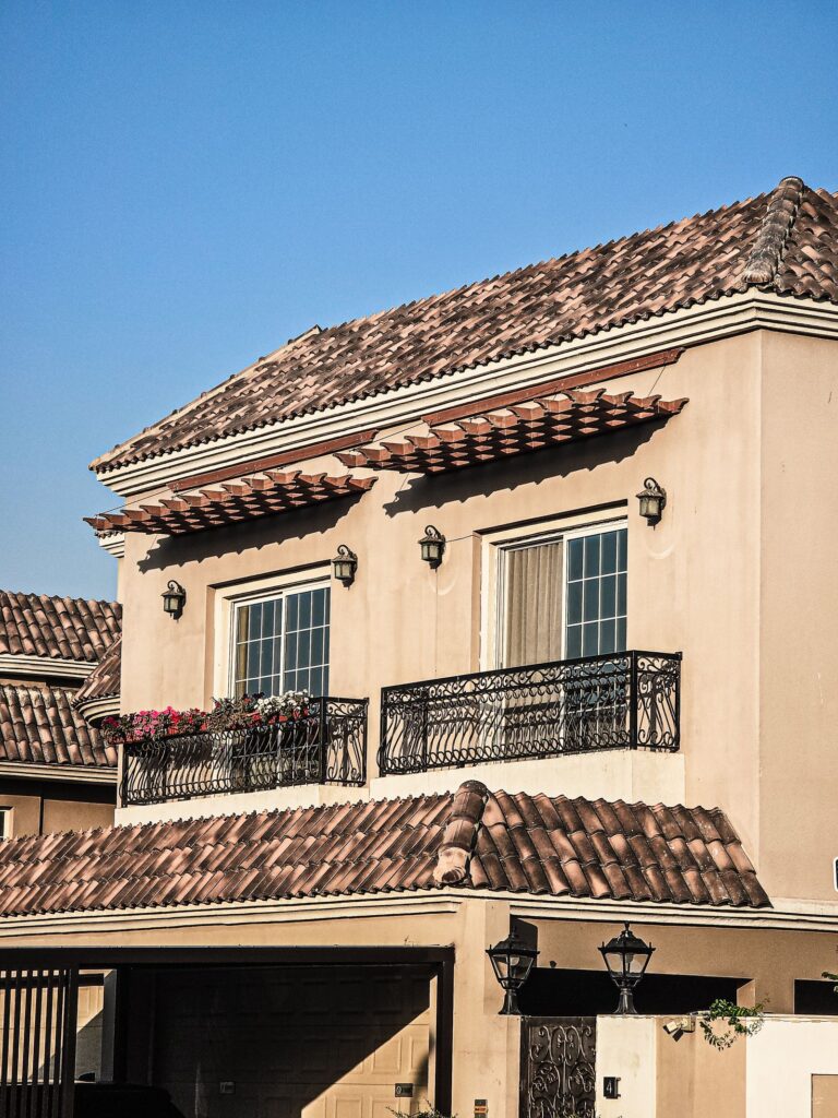 Mediterranean-style villa architecture in Dubai under a clear blue sky, representative of DAMAC Lagoons' themed clusters
