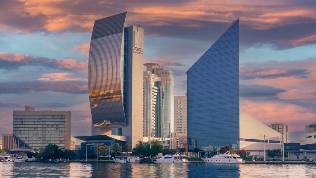 Dubai skyline at sunset with modern high-rise towers along the waterfront
