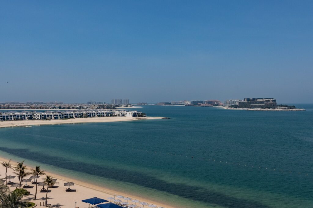 Aerial view of a Palm Jumeirah villa frond with private beach and turquoise water, Dubai
