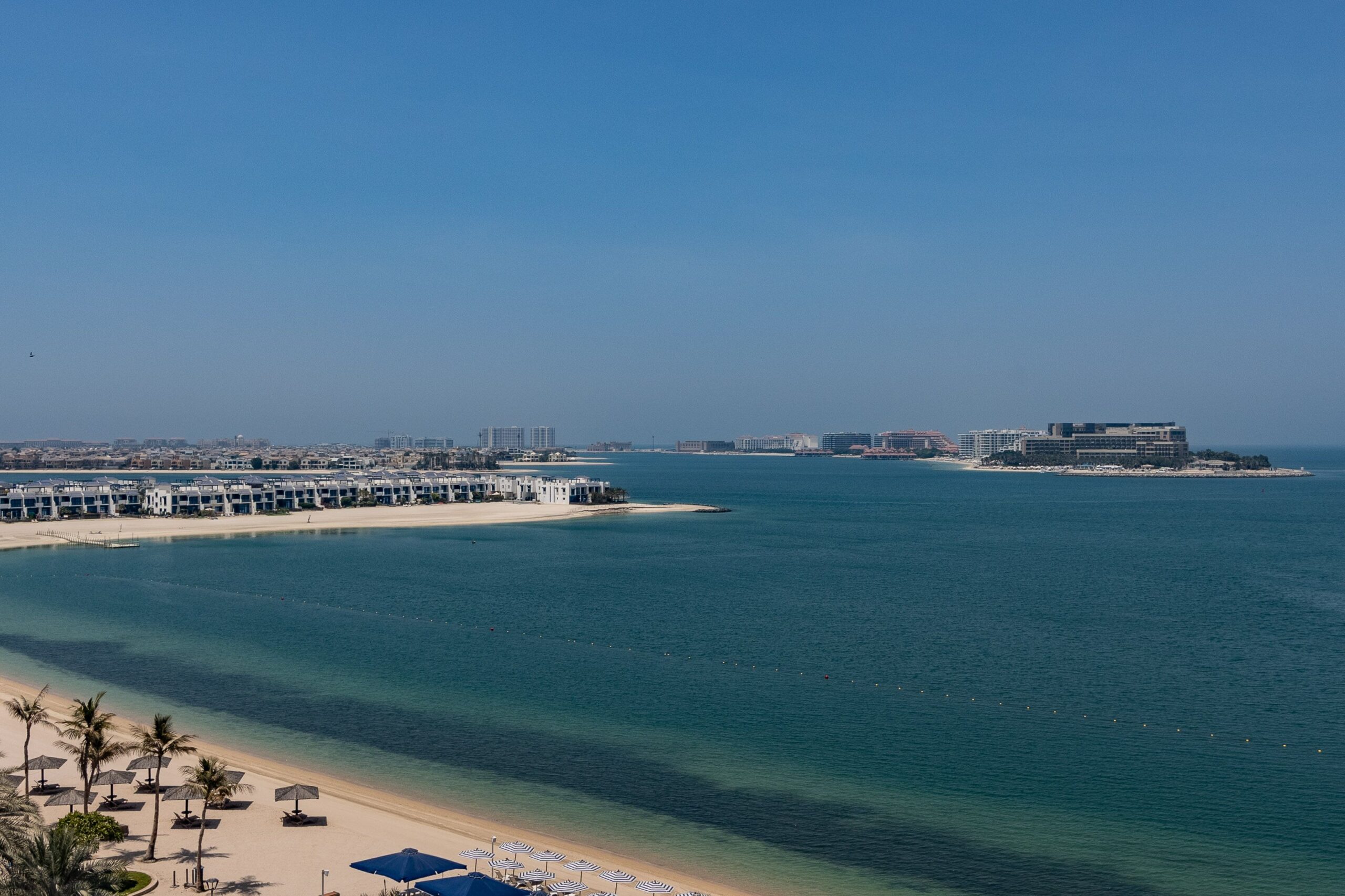 Aerial view of a Palm Jumeirah villa frond with private beach and turquoise water, Dubai