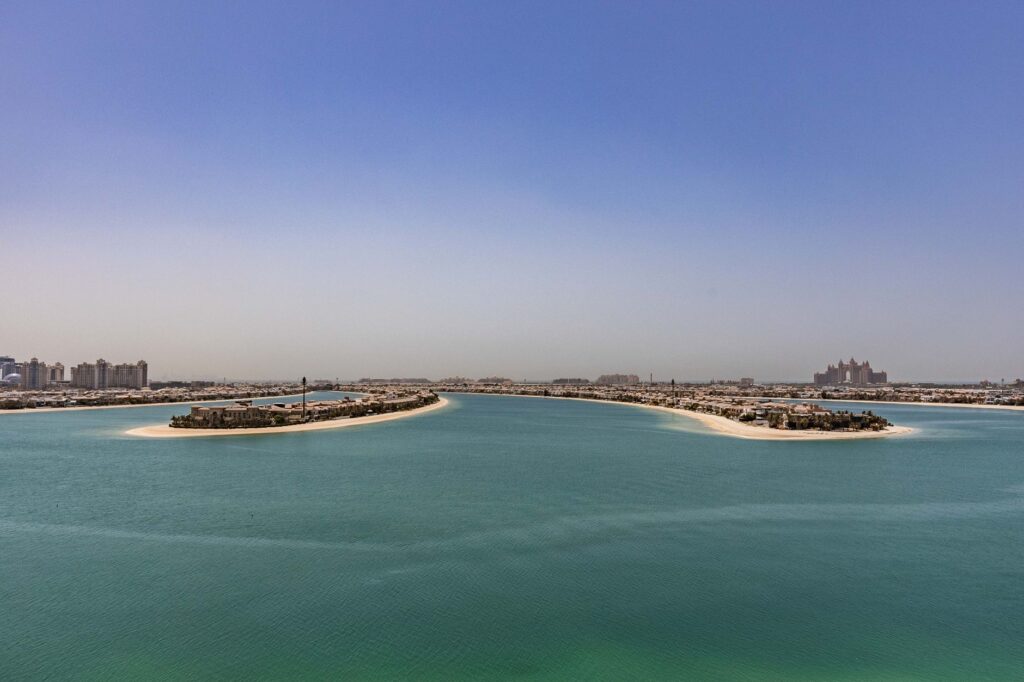 Aerial view of Palm Jumeirah frond tips with villa communities and turquoise water, Dubai