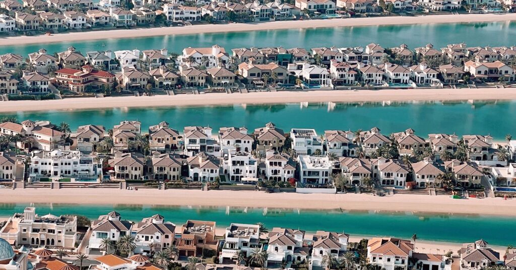 Aerial view of Palm Jumeirah frond villa rows with turquoise water channels, Dubai
