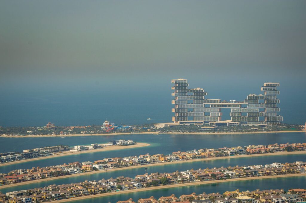 Aerial view of Palm Jumeirah frond villa rows with Atlantis The Royal in the background, Dubai