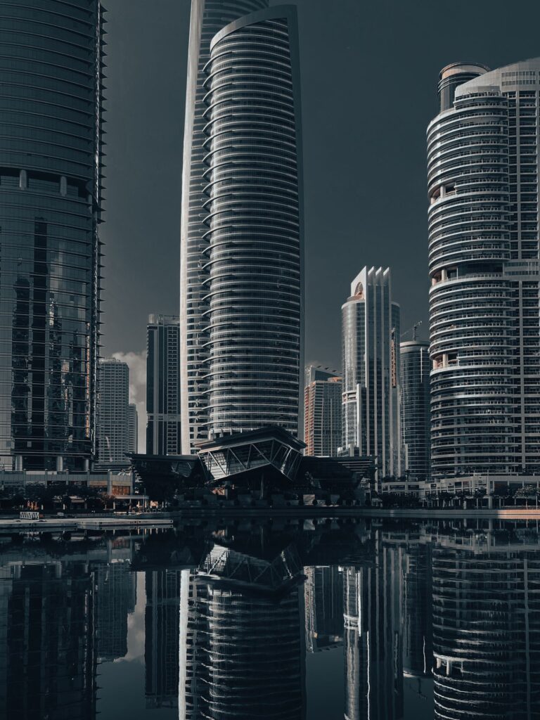 Modern skyscrapers reflected in the lake at Jumeirah Lake Towers, Dubai