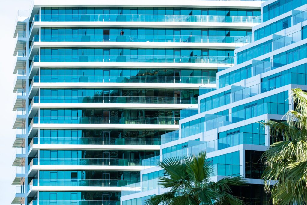 Modern teal glass balcony facade of a high-rise tower in Dubai Marina, near LIV Residence