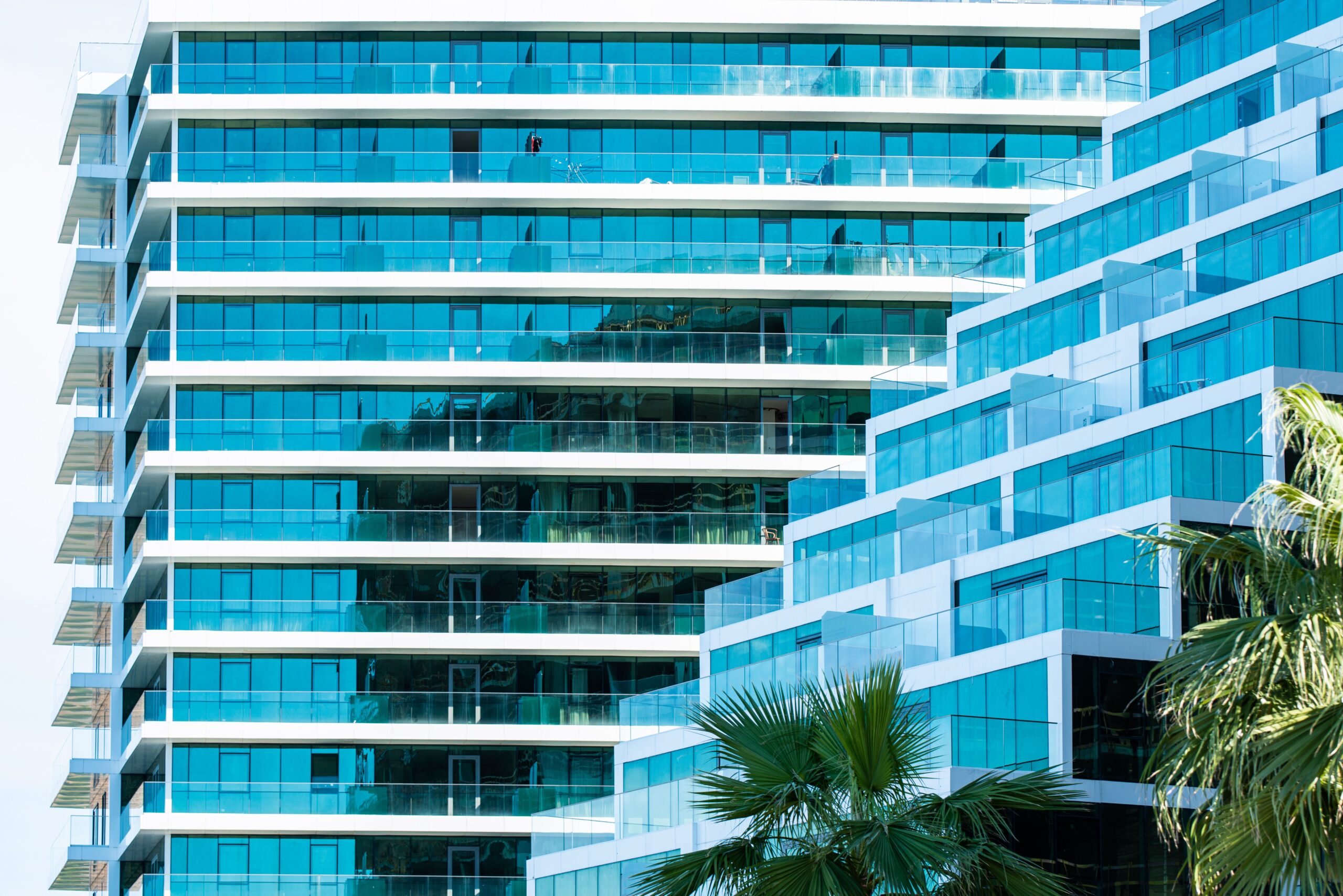 Modern teal glass balcony facade of a high-rise tower in Dubai Marina, near LIV Residence