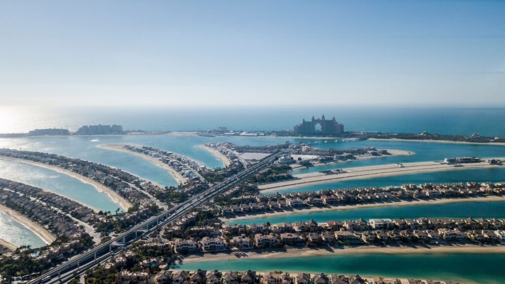 Aerial view of Palm Jumeirah's fronds and trunk with Atlantis The Palm in the background on a clear day