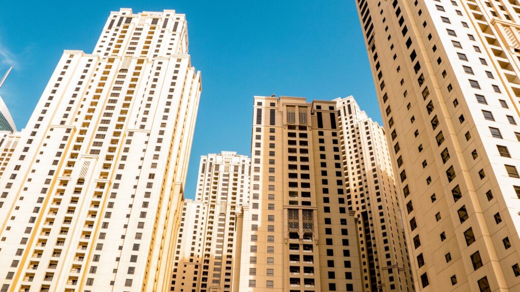 Dubai high-rise apartment towers against a clear blue sky near Business Bay