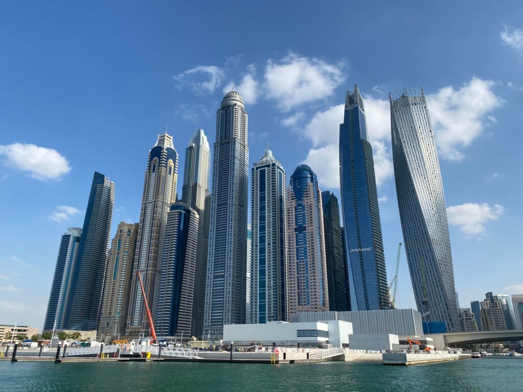 Clean daytime view of Dubai Marina's modern high-rise tower cluster under a clear blue sky