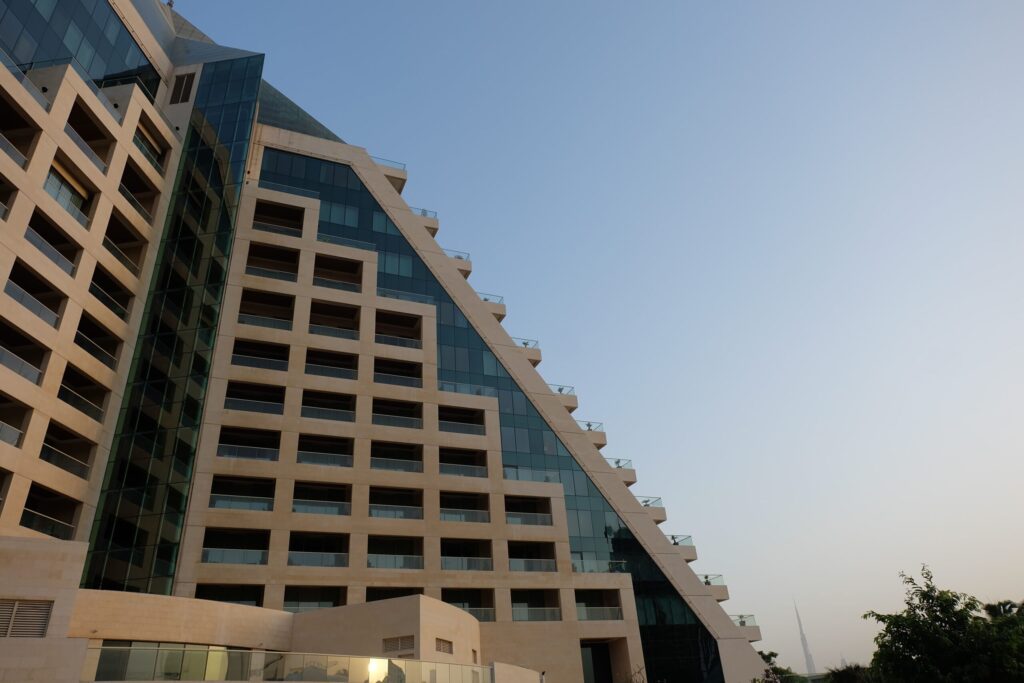 Stepped glass and stone tower facade in Dubai in warm afternoon light