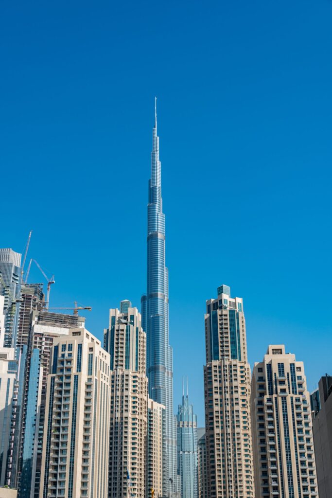 Cluster of residential high-rise towers with the Burj Khalifa spire rising behind them