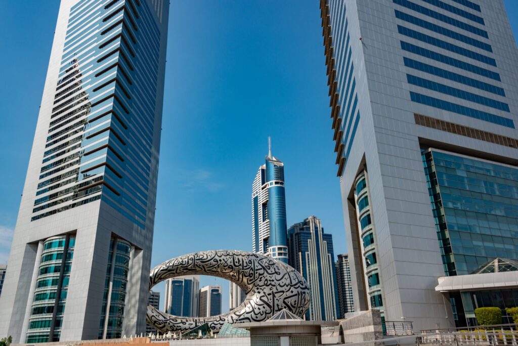 Street-level view of the Museum of the Future and DIFC Gate towers on Sheikh Zayed Road, Dubai