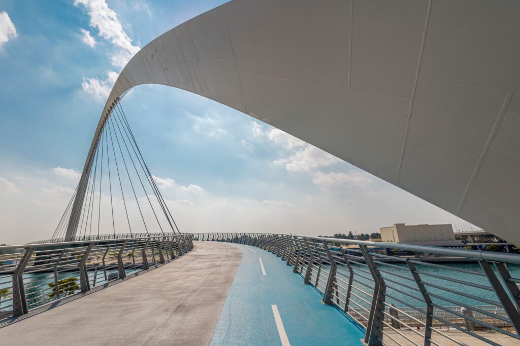 Tolerance Bridge over the Dubai Canal with a dedicated cycling and walking track in the foreground