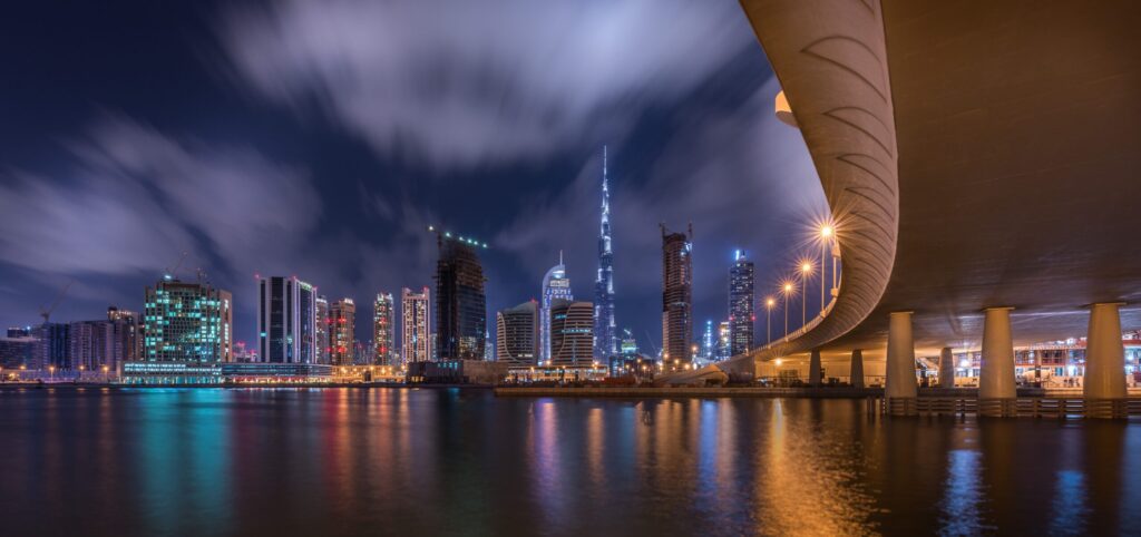 Night view of the Business Bay canal with the illuminated Burj Khalifa in the distance, Dubai