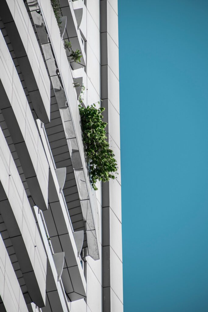 Modern residential building facade with balconies and greenery under blue sky in DIFC, Dubai, representing Limestone House