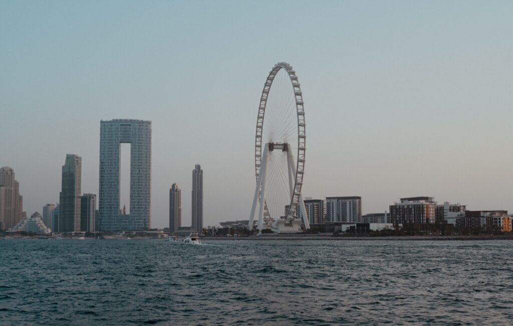 Dusk skyline view of Ain Dubai observation wheel and JBR-area towers seen across the water