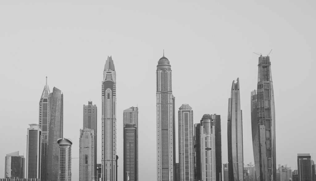 Black and white silhouette of the Dubai Marina skyline at dusk