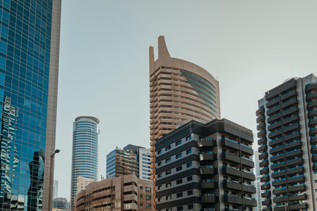 Low angle view of modern glass skyscrapers in Dubai against a clear sky