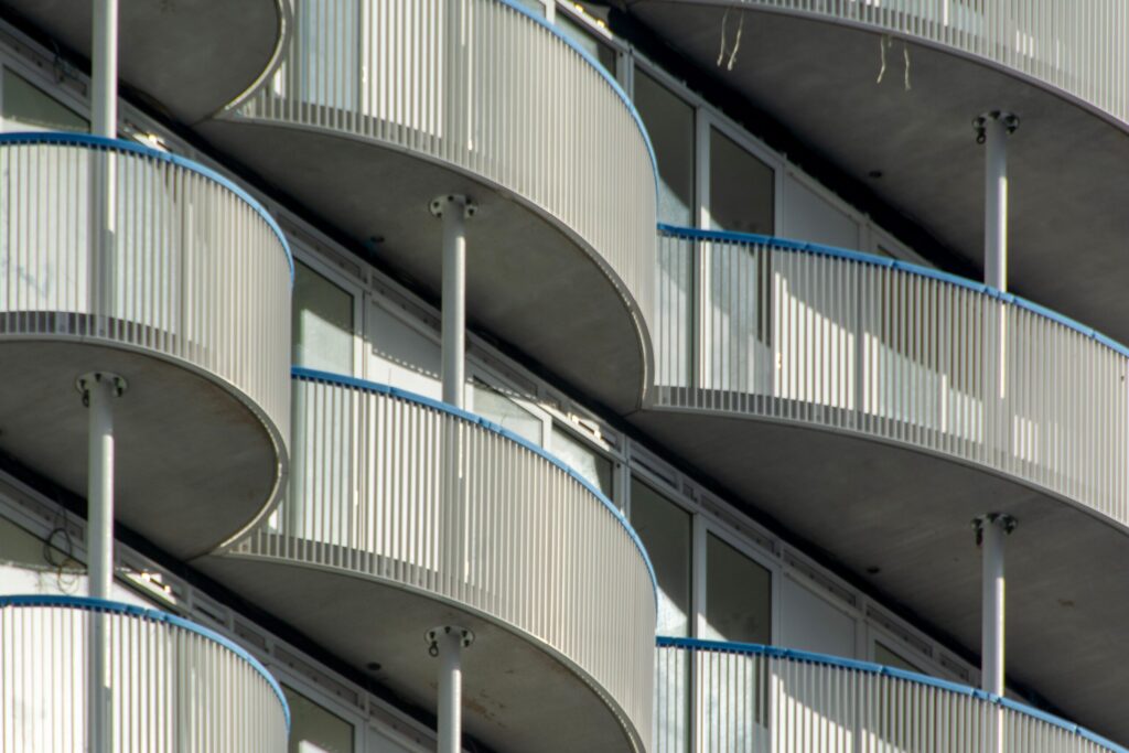 Close-up view of a modern high-rise building showcasing curved balcony architecture