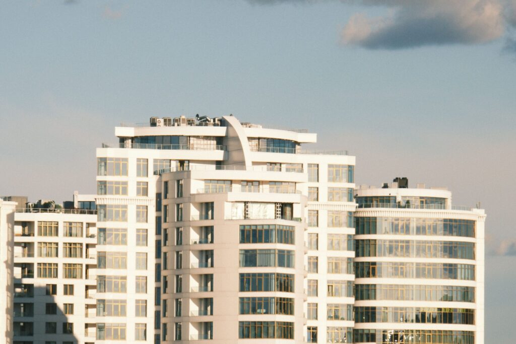 Contemporary high-rise buildings with a clear blue sky backdrop, capturing urban architecture