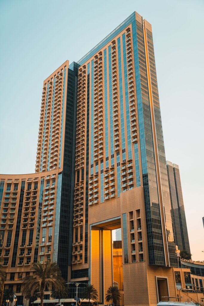 Golden hour view of a modern high-rise residential tower with balconies in Downtown Dubai
