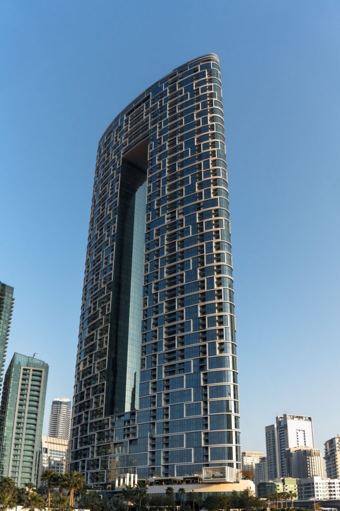 Modern skyscraper showcasing unique architectural design in Dubai under a clear blue sky