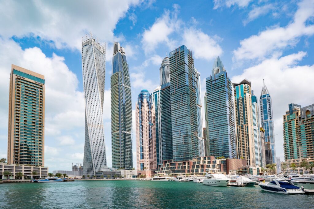 Daytime view of Dubai Marina waterfront skyline with the twisted Cayan Tower and a cluster of high-rise towers