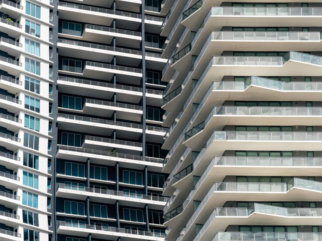 Close-up view of contemporary skyscrapers showcasing geometric balconies and cool-toned urban architecture