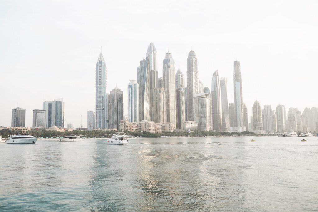 Dubai Marina waterfront skyline viewed from the water, yachts in foreground