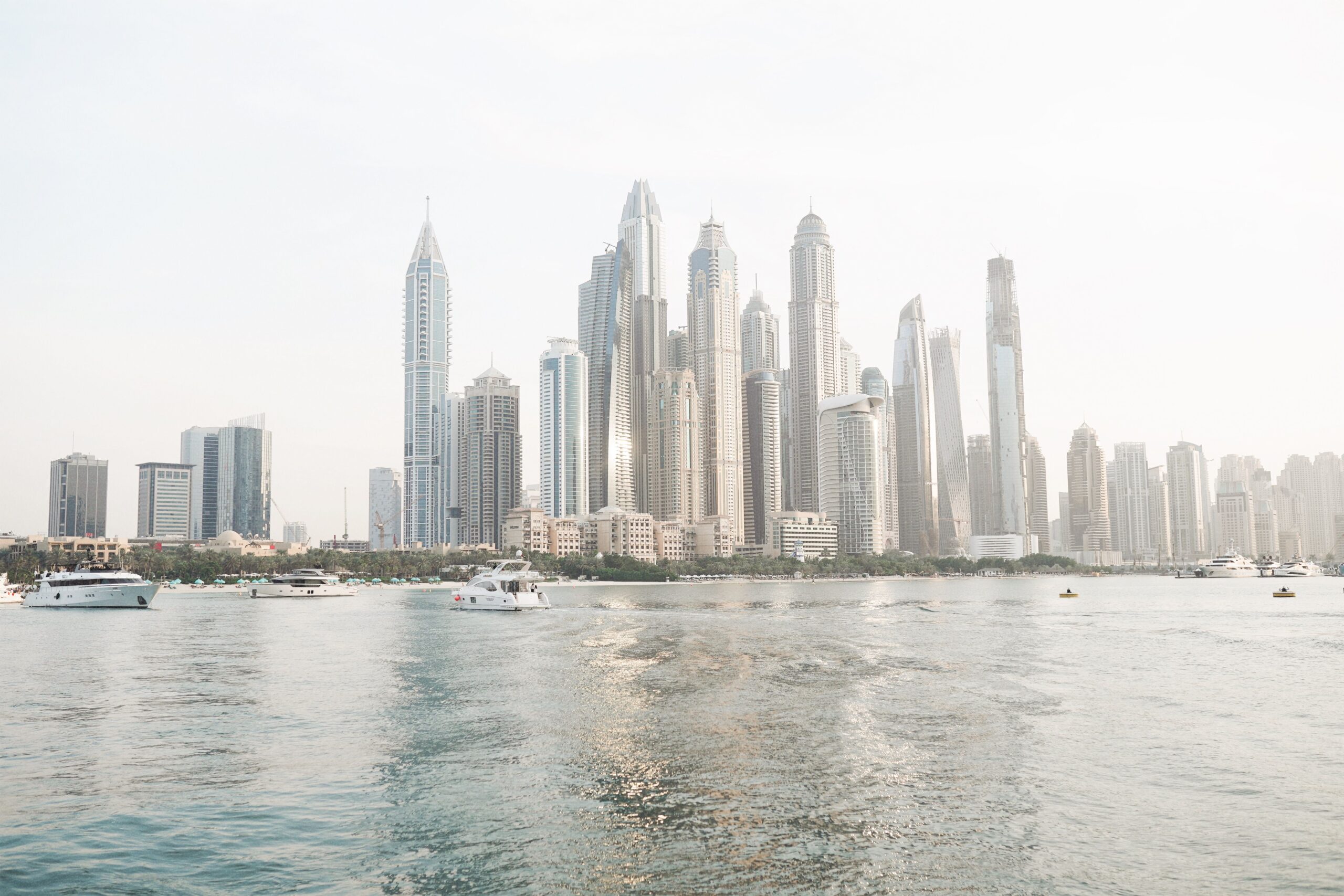 Dubai Marina waterfront skyline viewed from the water, yachts in foreground