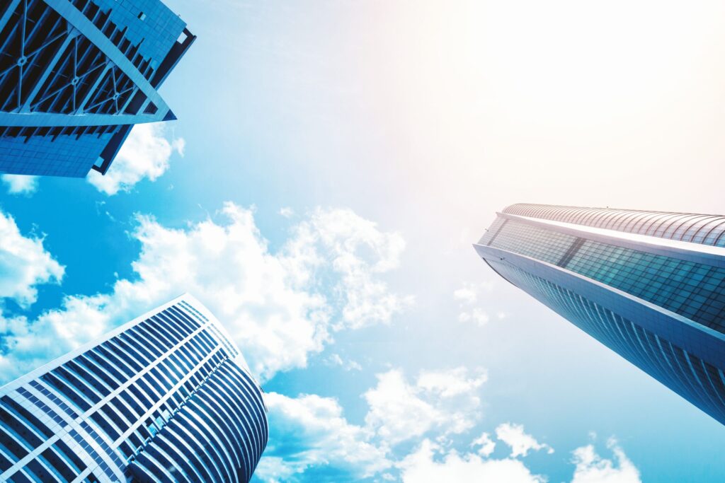 Upward view of modern skyscrapers against a vivid blue sky in Dubai Marina, showcasing contemporary architecture