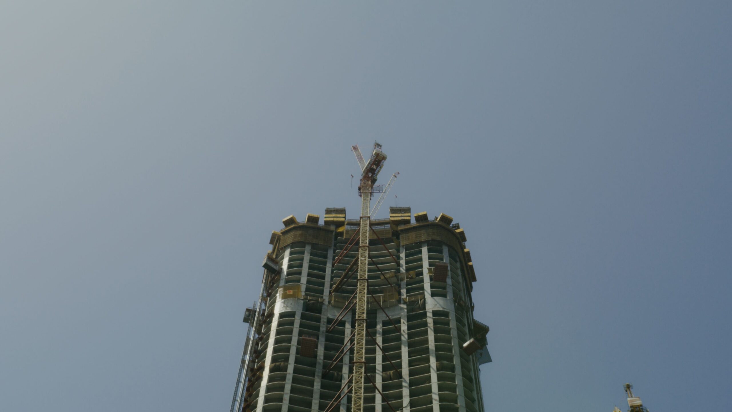 Tower under construction with crane against clear sky, Arjan, Dubai