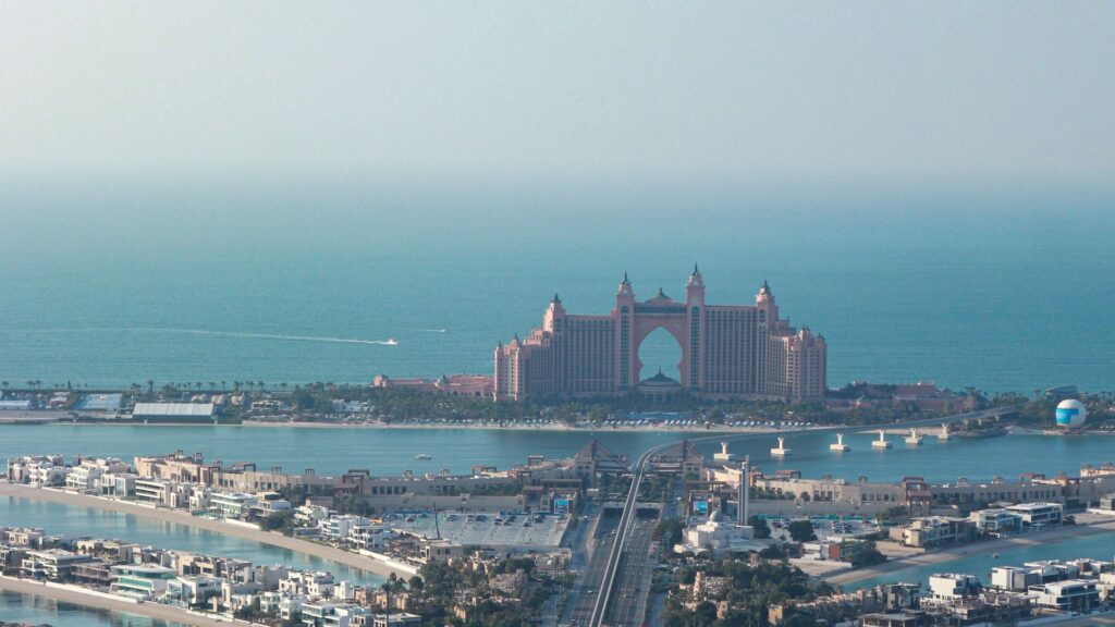 Aerial view of Atlantis The Palm hotel at the crescent of Palm Jumeirah with the trunk in the foreground