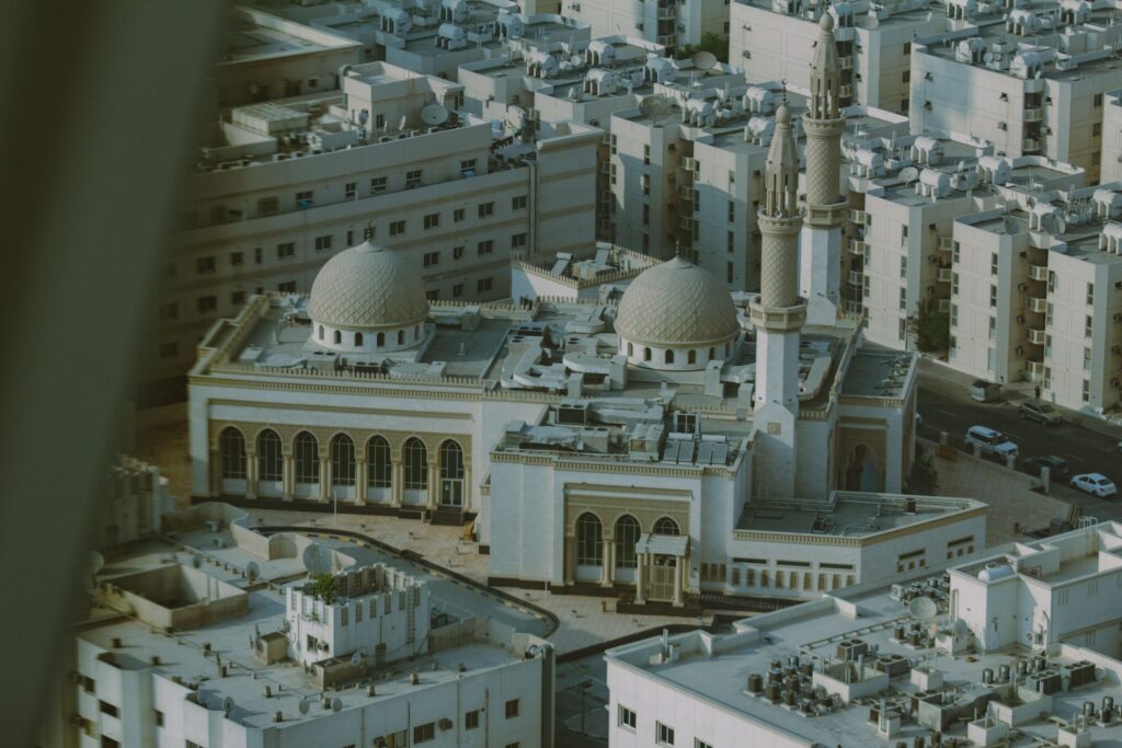 Aerial view of a mosque surrounded by residential blocks in Dubai