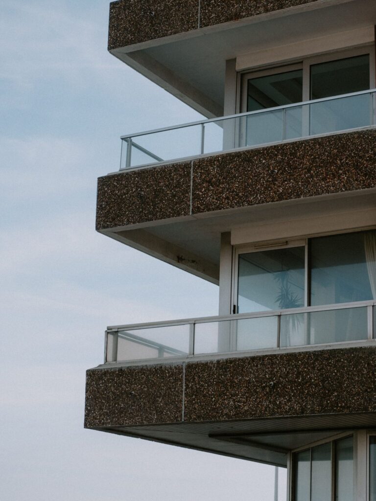 Close-up of a modern apartment building exterior with speckled concrete balconies in Dubai