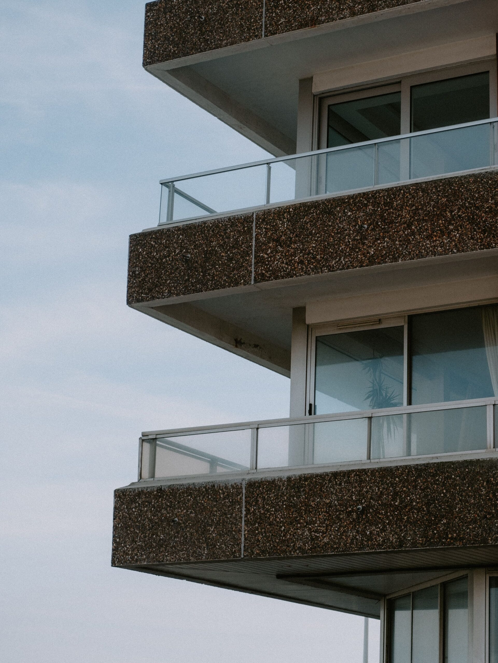 Close-up of a modern apartment building exterior with speckled concrete balconies in Dubai