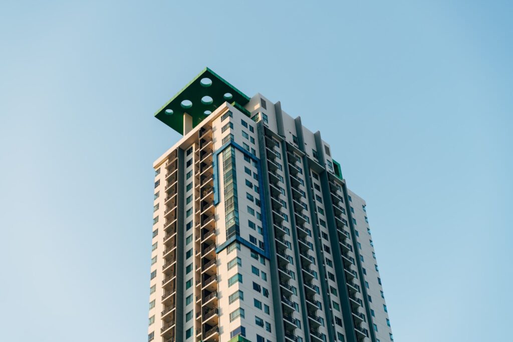 Residential tower with balconies against a clear blue sky