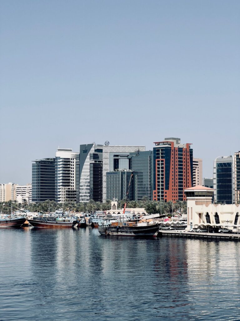 Dubai Creek waterfront skyline with traditional dhow boats, representative of the Healthcare City area near Kempinski Residences The Creek