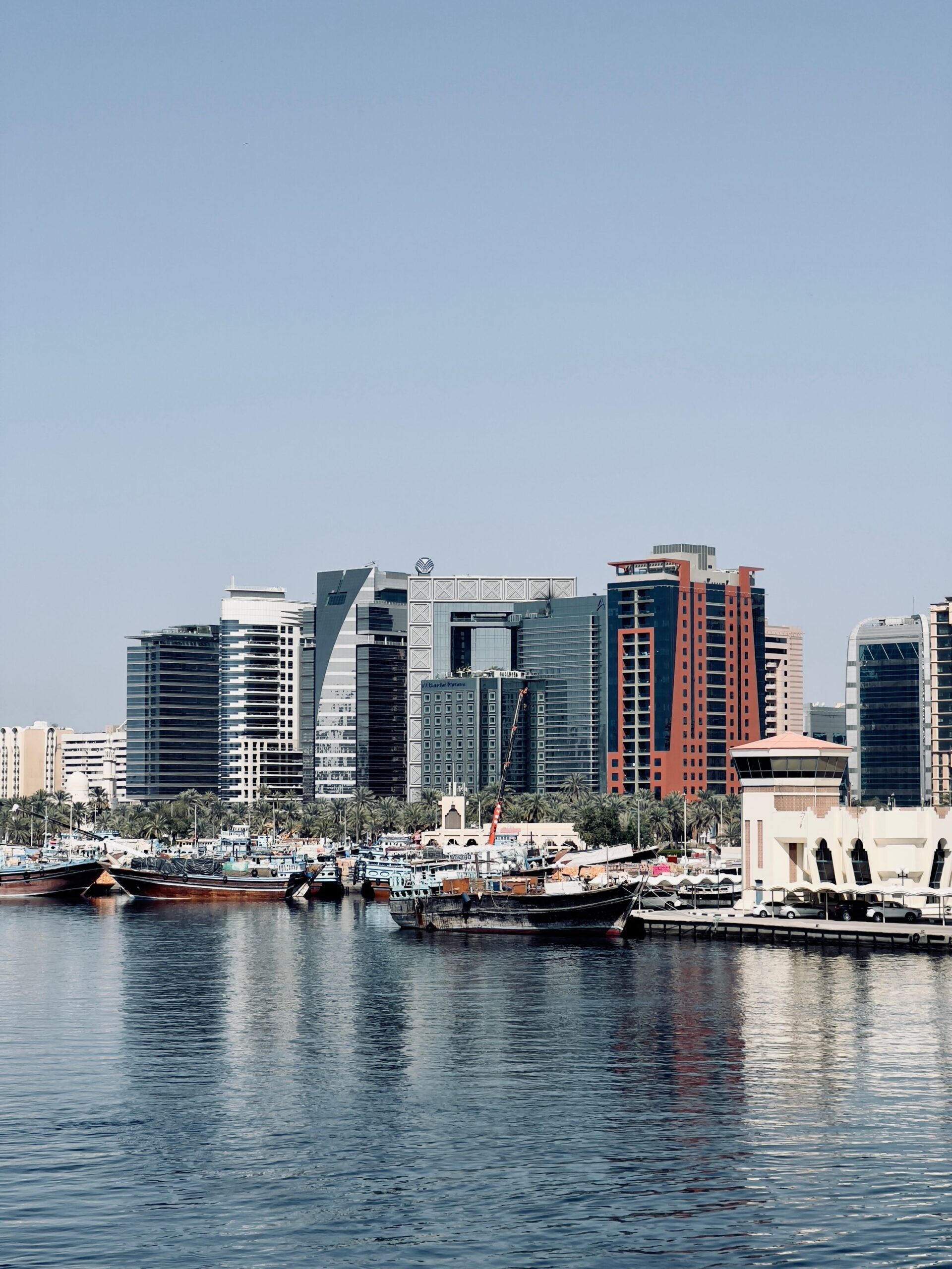 Dubai Creek waterfront skyline with traditional dhow boats, representative of the Healthcare City area near Kempinski Residences The Creek