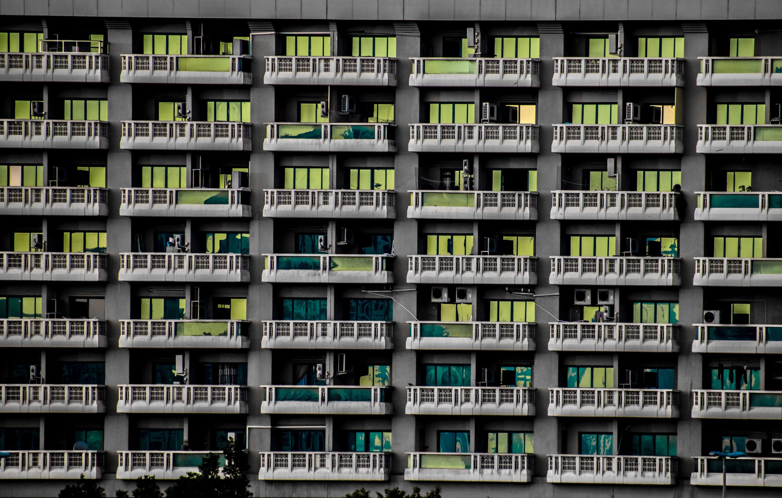 Urban high-rise residential building facade with repeated balconies and windows in Dubai