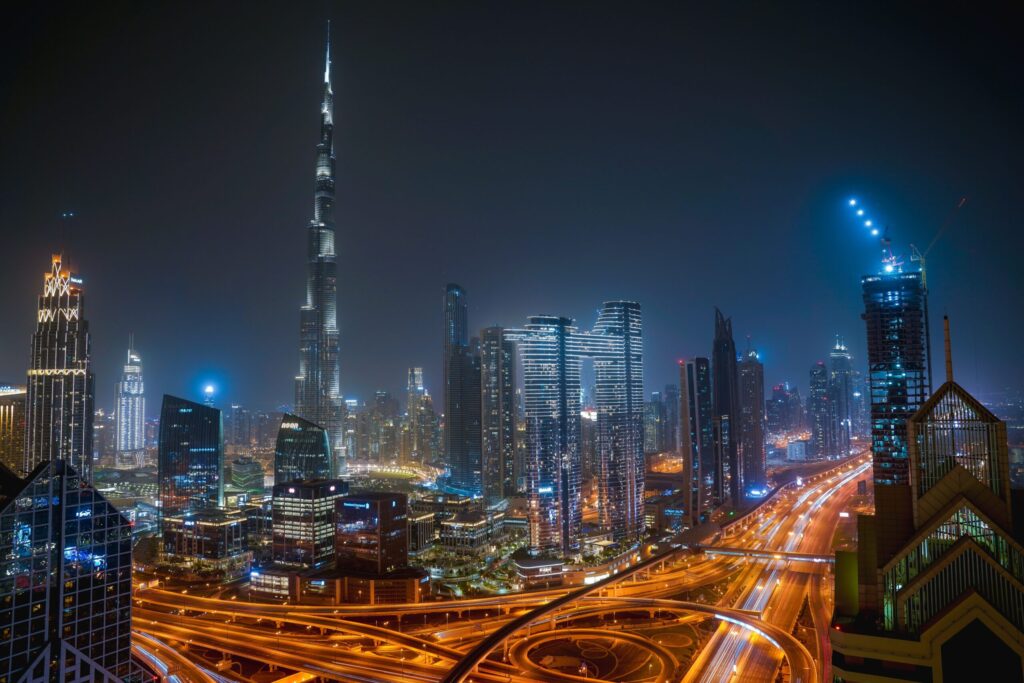 Downtown Dubai night skyline with Burj Khalifa and Sheikh Zayed Road traffic light trails, near Business Bay
