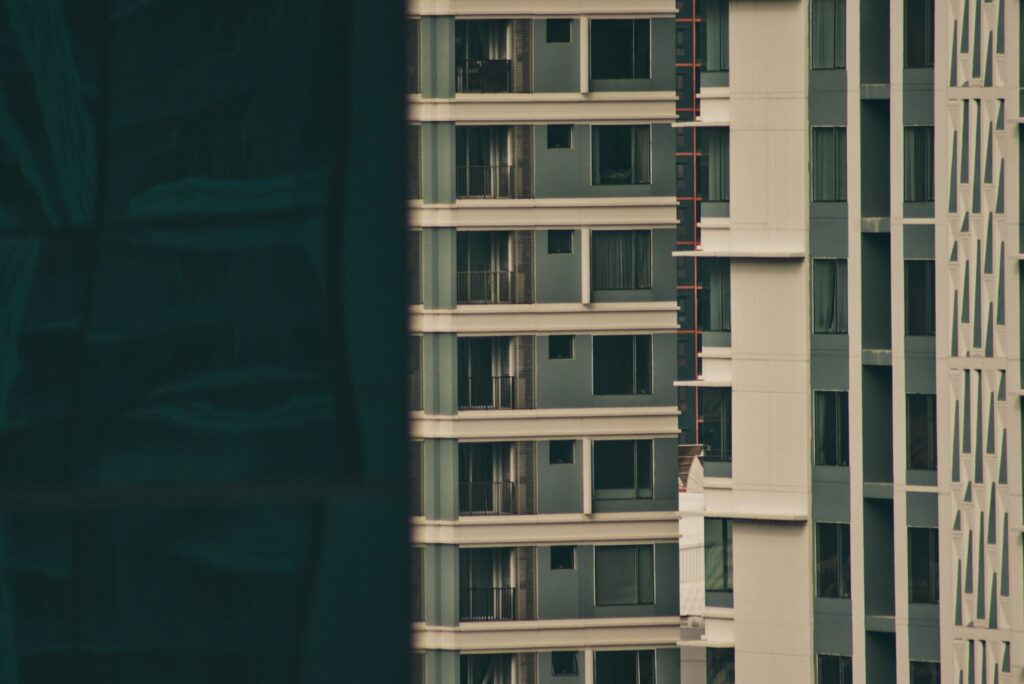 Close-up view of a modern high-rise apartment building facade in Dubai, similar in style to The Residence 6, JVC