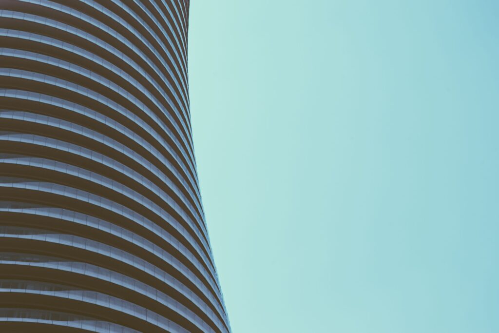 Curved residential tower facade against a clear sky near JAM Marina Residence, Dubai Marina