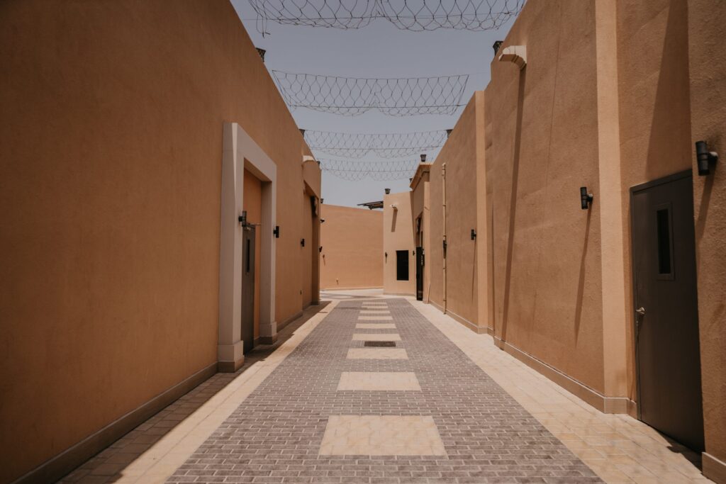 Sandstone-toned, Arabian-style alleyway with traditional wooden doors in Old Town, Downtown Dubai, near Yansoon 8